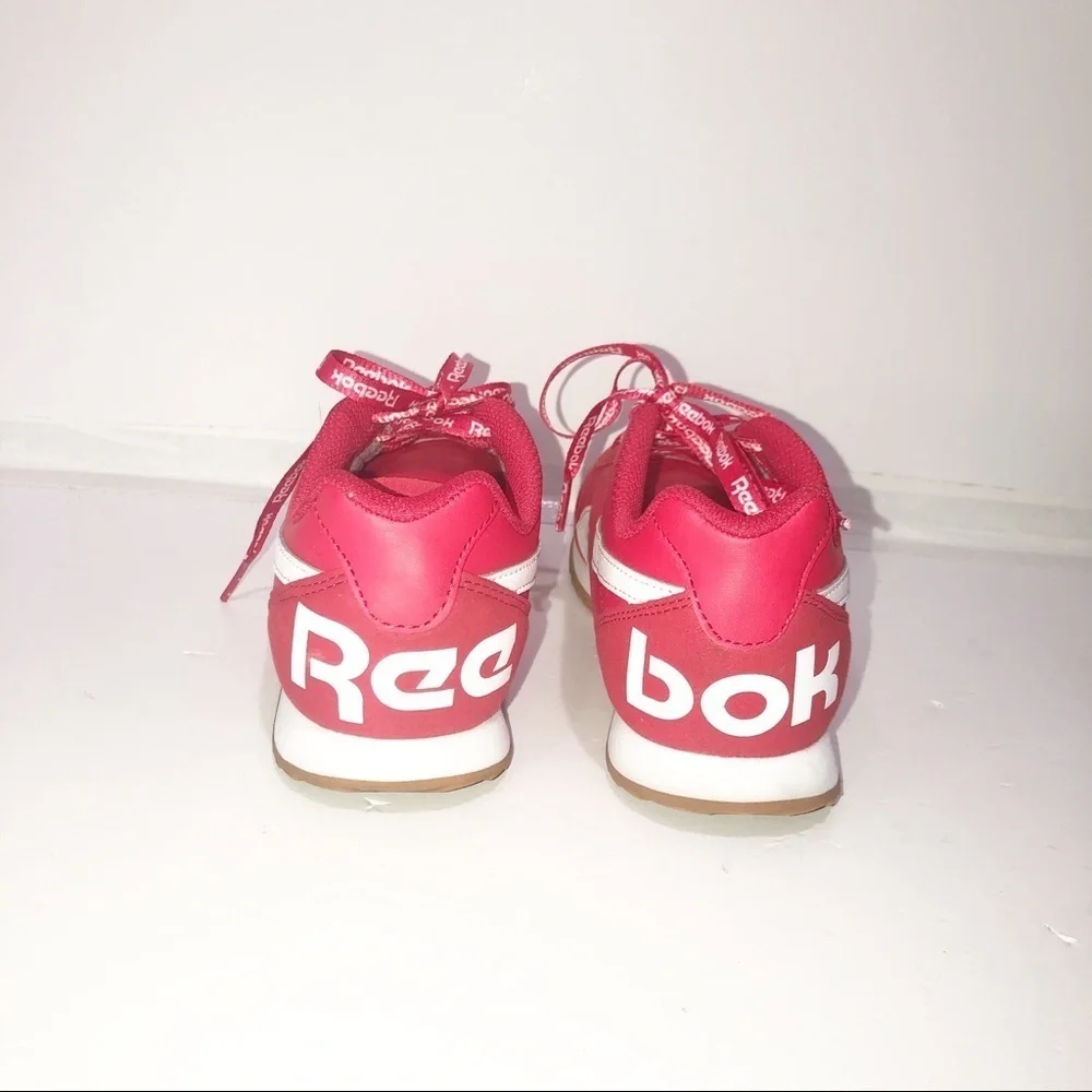 Reebok red classics with repeating logo strings.